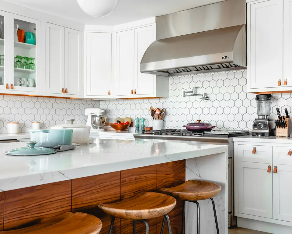 Bright kitchen with hexagon tile backsplash and white cabinets
