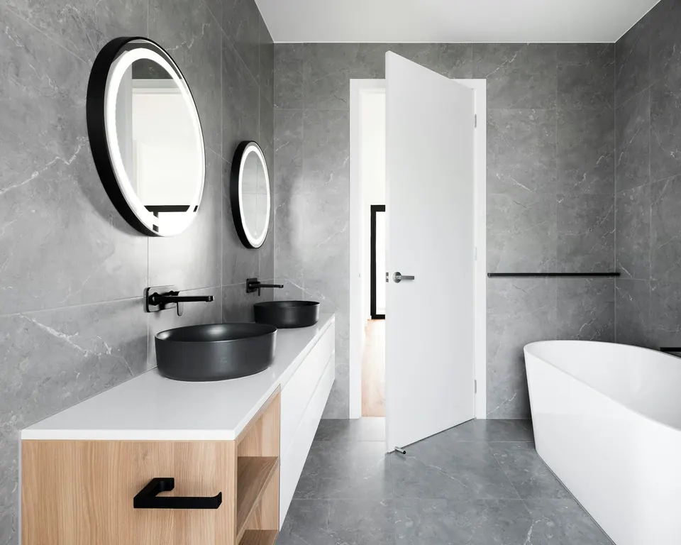 Bathroom with large-format grey marble-effect wall and floor tiles